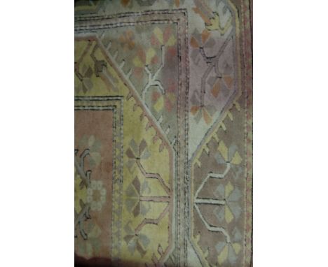 Turkish Caucasian pattern carpet, with five lozenge medallions on a washed red ground, white borders, 275cm x 215cm.
