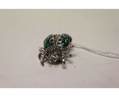 An unusual silver and enamel set ladybird brooch. 