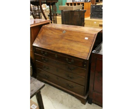 George III Mahogany Bureau, the front dropping down to reveal a fitted interior over four long drawers and raised on bracket 