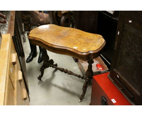 19th century Burr Walnut and Walnut Fold - Over Card Table, the shaped top raised on turned bulbous fluted supports and ceram