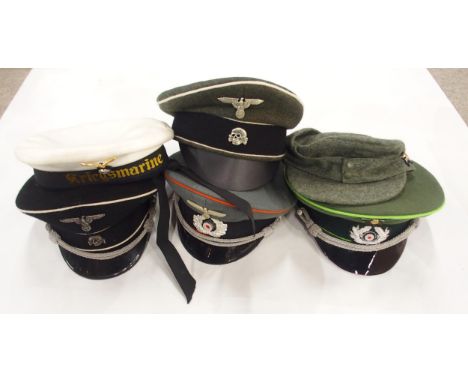 A quantity of WW2 German Third Reich-style headgear, including Waffen SS, Luftwaffe and Kriegsmarine officer's peaked caps, A