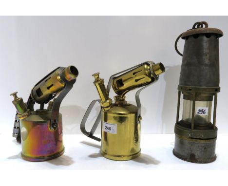 A William Maurice Ltd 'The wolf' safety lamp, and two antique blow torches Condition Report:Available upon request
