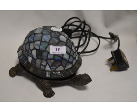 A modern Tortoise design table lamp with cast metal body and leaded light shade