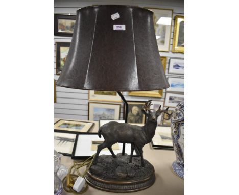 A modern Herredities style resin lamp base in the form of a stag with leather effect shade