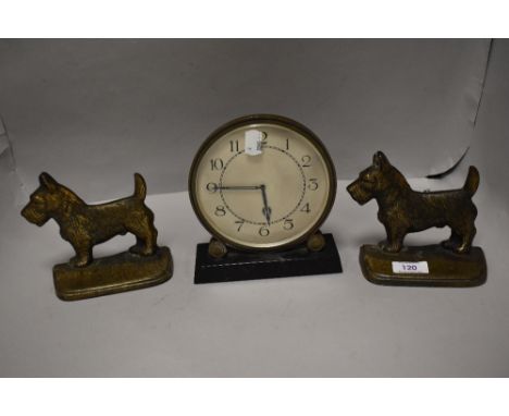 An Art Deco mantel clock having circular face with two cast Scottie dog door stops