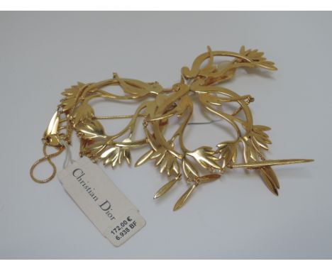 A single oversized stylised clip earring by Christian Dior with matching trinket with original tag