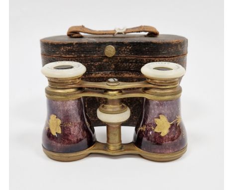 Pair of late 19th century French gilt metal opera glasses, the barrels with enamel decoration of gilt flowers, on a purple gr