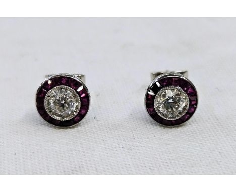 Pair white gold-coloured metal, diamond and ruby stud earrings, each with diamond approx. 0.5ct surrounded by rectangular cut