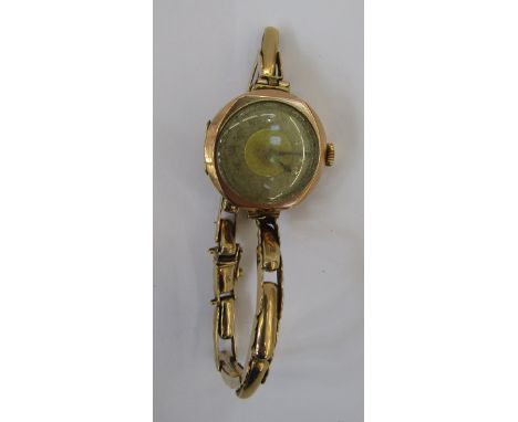 Lady's 9ct gold bracelet watch, the circular dial with engine turned decoration, the movement inscribed Buren, with expanding