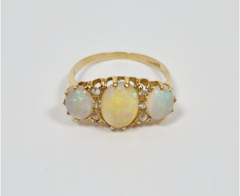 18ct yellow gold three stone opal and diamond set ring, hallmarks rubbed, 3.1 grams gross, size PCondition Reportopals have s
