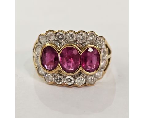 18ct gold, ruby and diamond ring, the three central rubies surrounded by diamonds, in rubover setting, modern, finger size O1