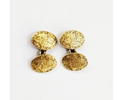 Pair of 18ct gold cufflinks by Saunders and Shepherd, London 1899, of oval form with engraved foliate decoration and chain li