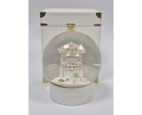 Louis Vuitton snowglobe in original box, the centre&nbsp;with a white and gilt model of the facade of the Asnieres headquarte