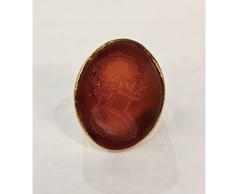 19th century gold-coloured metal and cornelian seal ring, the elliptical top intaglio engraved with portrait head and shoulde