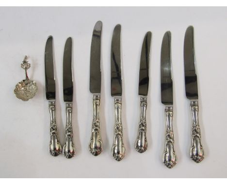 Seven sterling handled knives, floral and scroll decorated, and continental silver small caddy spoon with pierced and scroll 