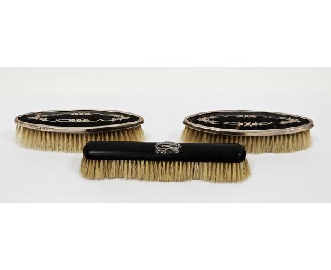 Pair of George V silver and tortoiseshell-backed dressing table brushes, Birmingham 1919, maker's marks rubbed, of oval form 