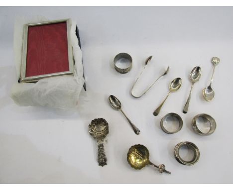 Collection of silver items including four napkin rings, sugar tongs, Queen Elizabeth II silver jubilee teaspoon, two Georgian