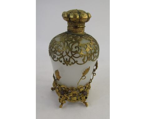 French gilt metal and opaque glass scent bottle, the mushroom stopper scallop-shaped and panelled, all overlaid with pierced 