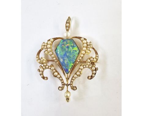 Edwardian gold pendant brooch, the central lozenge-shaped opal (possibly a doublet) within a scrolling framework set with see