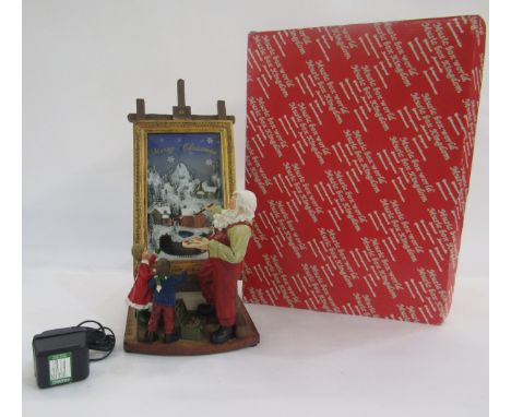 Music Box World resin Christmas model of Santa and two children beside light-up painting on easel (boxed with power cable).Co