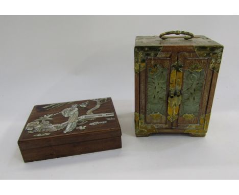 Chinese small hardwood cabinet with brass mounts, the double doors inset with pierced jade panels and revealing three drawers