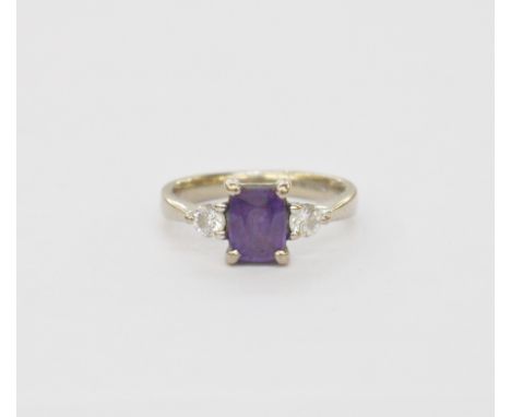 18ct white gold, purple sapphire and diamond three-stone dress ring, the rounded rectangular purple sapphire approx. 1.25ct f