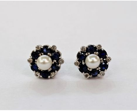 Pair of white metal, pearl, sapphire and diamond stud earrings, each set with a central cultured pearl surrounded by six circ