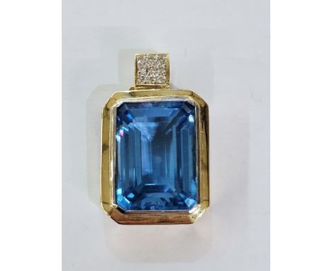 18ct gold, blue topaz and diamond pendant, the rectangular cut topaz with small diamond set loop above and garnet set pendant