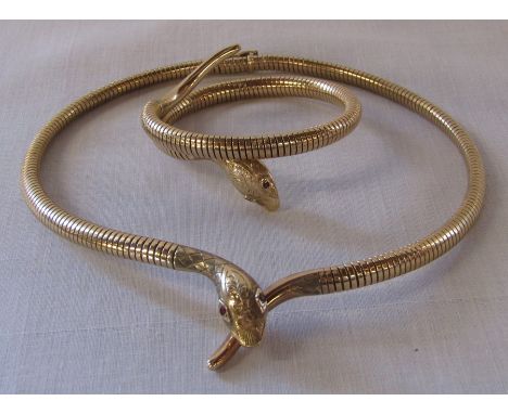 9ct gold snake necklace with ruby set eyes 29.5 g marked S &amp; P together with a coiled 9ct gold snake bracelet 21.5 g with