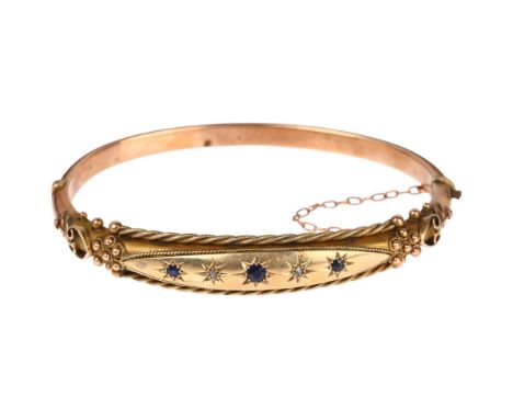 A Victorian 9ct rose gold sapphire and diamond hinged bangle, with applied rope twist and floral decoration, setting height 1