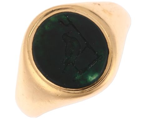 An early 20th century 18ct gold bloodstone seal signet ring, indistinct maker, London 1923, intaglio carved depicting bird wi