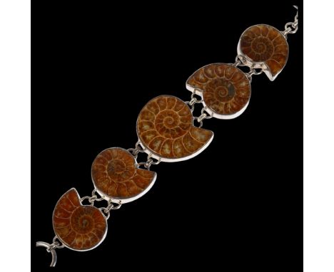 A sterling silver graduated ammonite fossil panel bracelet, 23cm, 76gNo damage or repair, all stones present, no broken links
