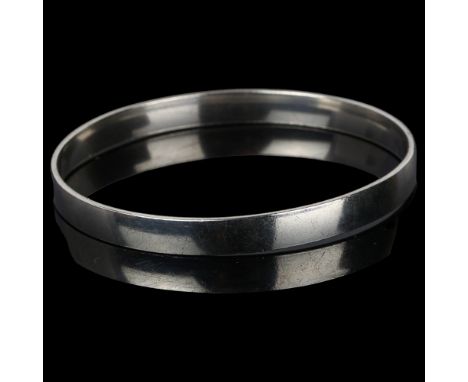 A Danish modernist sterling silver plain form slave bangle, band width 6.8mm, internal circumference 19cm, 22.3gNo damage or 