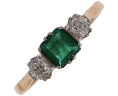 An 18ct gold three stone emerald and diamond ring, platinum-topped, claw set with 0.25ct rectangular step-cut emerald flanked