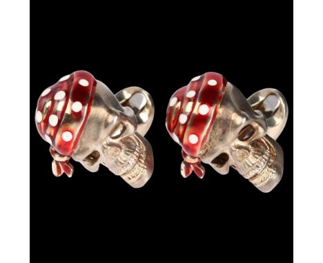 DEAKIN & FRANCIS - a pair of sterling silver enamel and ruby pirate skull cufflinks, hidden ruby eyes only revealed if the ja