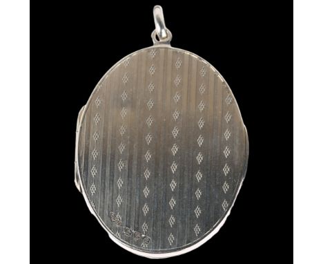 A large early 20th century silver photo locket pendant, maker FFB, Chester 1917, allover engine turned decoration, 60.7mm, 24