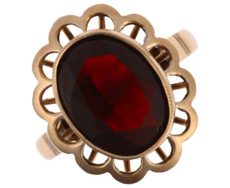 A late 20th century 14ct gold garnet flowerhead ring, rub-over set with oval mixed-cut garnet, setting height 18.9mm, size R,