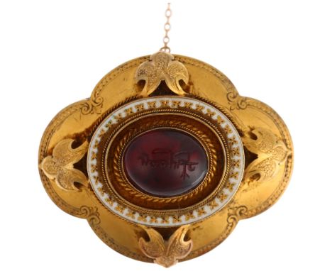 A Victorian garnet memorial brooch, centrally rub-over set with foil-back oval cabochon garnet, with Arabic? engraving, withi