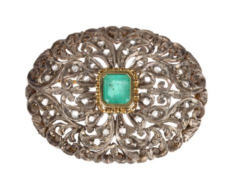 An emerald and diamond oval bombe brooch, unmarked gold and silver settings with central emerald step-cut emerald and pierced