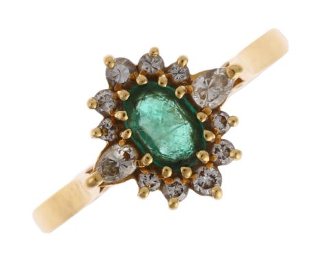 An 18ct gold emerald and diamond oval cluster ring, maker ST, London 1988, claw set with oval mixed-cut emerald surrounded by