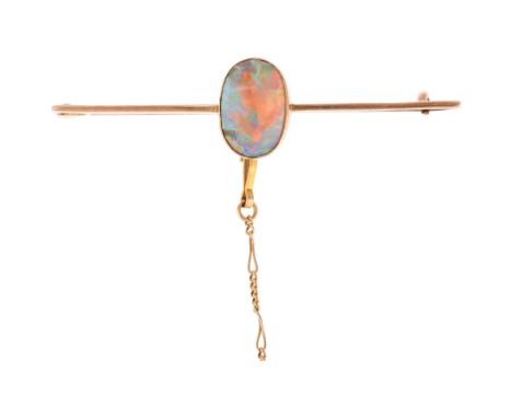 An early 20th century 9ct rose gold opal bar brooch, rub-over set with oval flat cabochon opal measuring approx: 9.9 x 6.7 x 