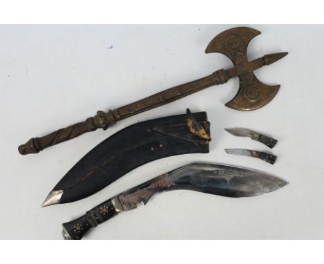 An Indian kukri knife with lion head pommel and leather scabbard and a decorative iron axe. [2]

Note: This lot is not for sa