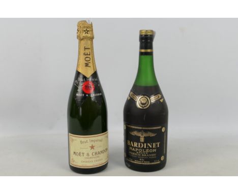 A 35 fl oz bottle of Bardinet brandy, 70° proof, level upper shoulder and a 750ml bottle of NV Moet &amp; Chandon Brut champa