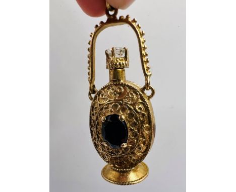 A 9ct gold scent bottle set with rock crystal and garnet. Hallmarked 1966 for London. Sponsor's mark FM. Length (including ju