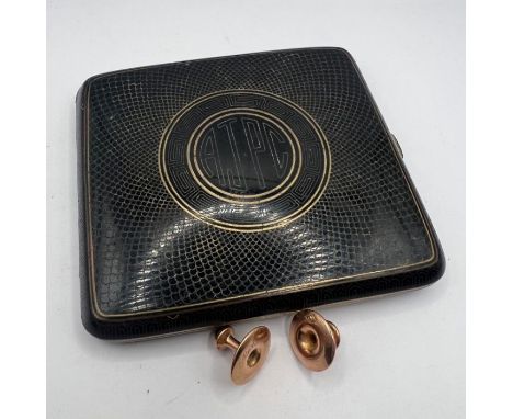 A black enamel and gilt cigarette case with engine turned and Greek key patterns; plus a pair of 9ct gold dress studs (approx