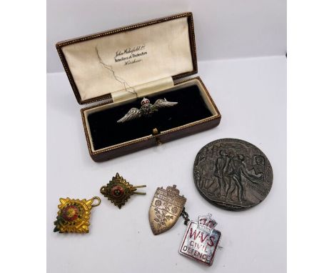 A 9ct white gold and enamel, diamond chip set RAF sweetheart brooch in a vintage box; plus a sterling silver nurses badge; a 