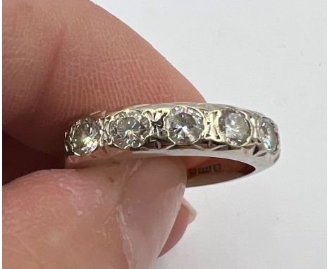 A five stone diamond half eternity ring in 18ct white gold. Set with five round brilliant cut diamonds, estimated total weigh