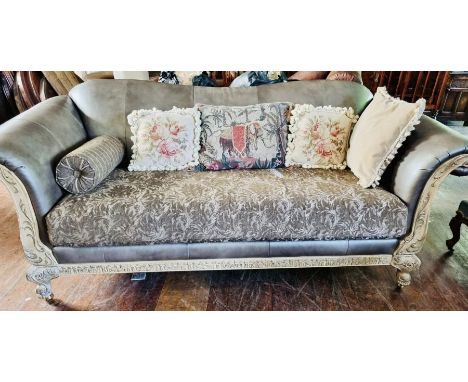 A Schnadig gilt painted wood three seater sofa, serpentine back rest scrolling arm rests, above a foliage carved apron, raise