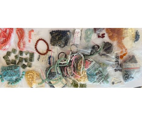 A large collection of hardstone beads including aquamarine, turquoise, honey jade, amber, cherry amber, lapis lazuli, hematit