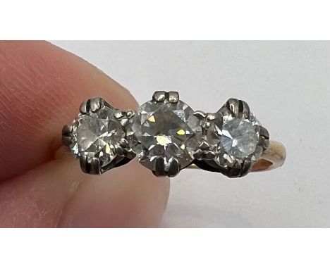 A three stone diamond ring, approximate total diamond weight 0.90ct. Yellow metal, unmarked but tests as 18ct gold. Size I, G